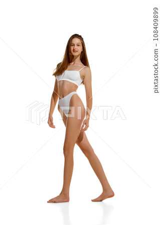 Full length portrait of beautiful lady posing in white lingerie showing her ideal curves isolated studio background. 108409899