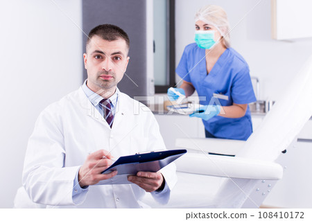 Cosmetician working with papers Cosmetician working with papers 108410172