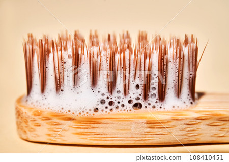 Toothbrush with toothpaste foam close-up. Toothbrush with toothpaste foam close-up. 108410451