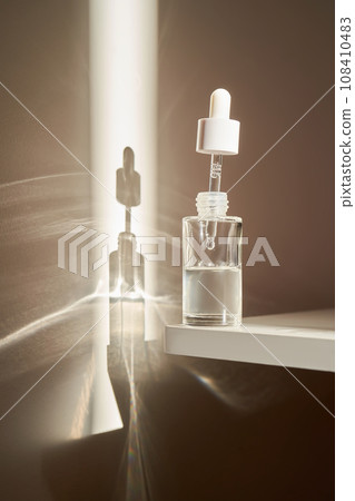 A transparent bottle of serum under the morning sun. A transparent bottle of serum under the morning sun. 108410483