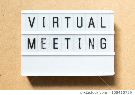 Lightbox with word virtual meeting on wood background Lightbox with word virtual meeting on wood background 108410739