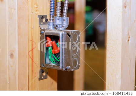 Electrical metal socket box wiring cable inside interior walls of under construction house Electrical metal socket box wiring cable inside interior walls of under construction house 108411433