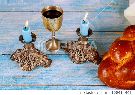 Sabbath essence homemade challah bread, kosher wine, candles, jewish holiday spirit Sabbath essence homemade challah bread, kosher wine, candles, jewish holiday spirit 108411441