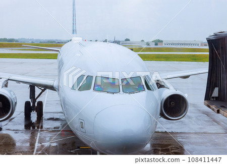 It is time for passenger plane to be serviced by ground services before it takes off again in airport It is time for passenger plane to be serviced by ground services before it takes off again in airport 108411447