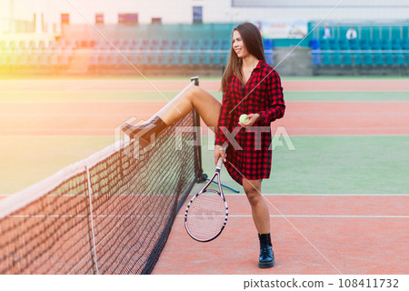 Beautiful stylish sexy woman in black trendy sportswear on tennis court. 108411732