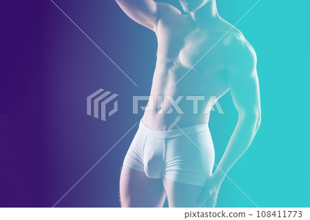 Portrait of young adult strong man in white briefs, studio shot. Sport and muscles Portrait of young adult strong man in white briefs, studio shot. Sport and muscles 108411773