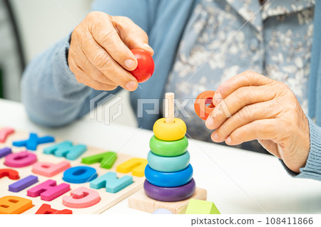 Alzheimer disease AD, Asian elderly woman patient suffering from dementia learn practical motor skills rehabilitation. 108411866