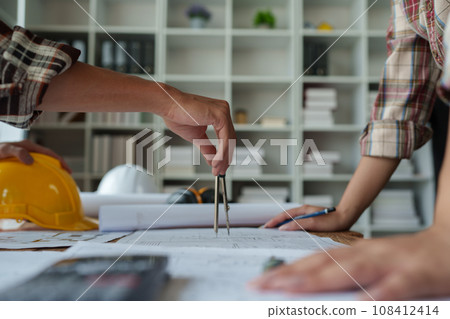 Engineers, designers and interior designers are finalizing the design of interiors by discussing selecting materials and colors to design rooms to present to clients 108412414