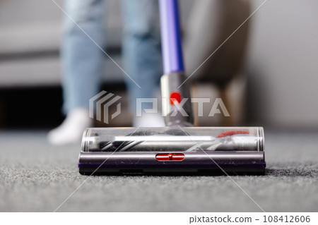 Vacuum cleaner on the floor. House cleaning concept. Modern vacuum cleaner while vacuuming. Cleaning service Vacuum cleaner on the floor. House cleaning concept. Modern vacuum cleaner while vacuuming. Cleaning service 108412606