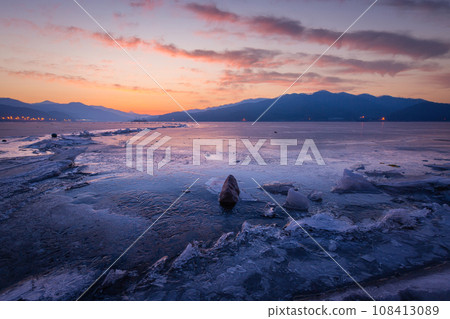 Frozen lake in South Korea in winter in sunrise at Dumulmeori, Yangpyeong, South Korea. Frozen lake in South Korea in winter in sunrise at Dumulmeori, Yangpyeong, South Korea. 108413089