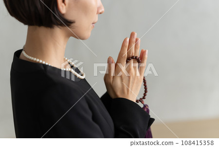 woman attending a funeral woman attending a funeral 108415358