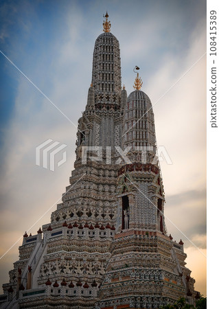 The magnificent Wat Arun temple in Bangkok, Thailand stands tall, boasting its ornate structure with numerous tiers and spires, all intricately adorned with exquisite patterns and statues. 108415389