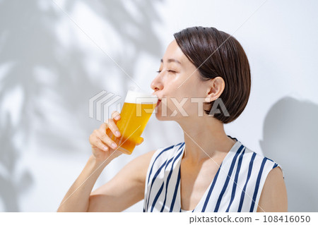Woman drinking beer Woman drinking beer 108416050