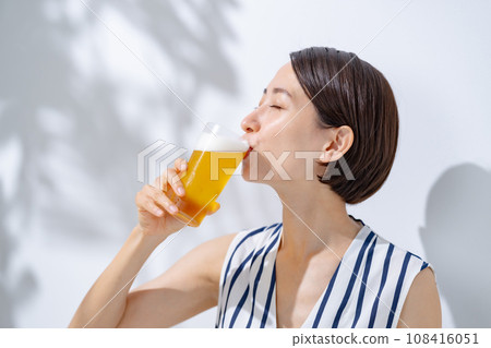 Woman drinking beer Woman drinking beer 108416051
