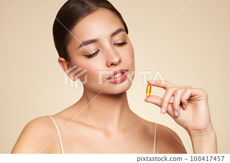 Beautiful Girl With Pill With Cod Liver Oil Omega-3 Beautiful Girl With Pill With Cod Liver Oil Omega-3 108417457