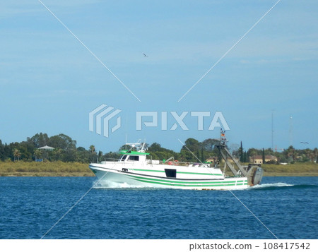 Boat sailing through the sea on a summer day 108417542