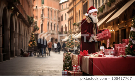 A salesman in a Santa suit lays out gift boxes on the counter. 108417767