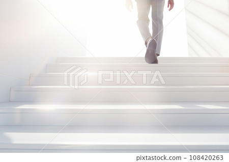 Businessman climbing the stairs towards the light Businessman climbing the stairs towards the light 108420263