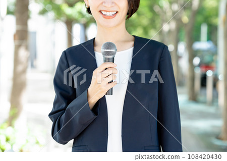 woman holding a microphone 108420430