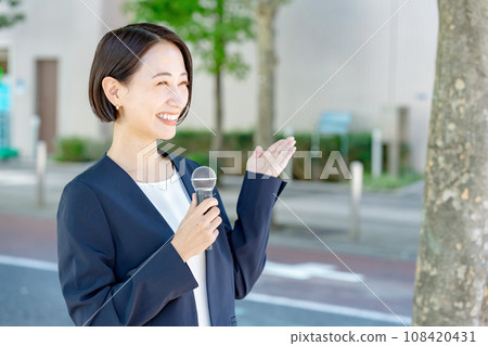 woman holding a microphone 108420431