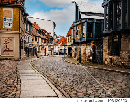 small town with old vintage small colored houses and old cobblestone pavement small town with old vintage small colored houses and old cobblestone pavement 108420850
