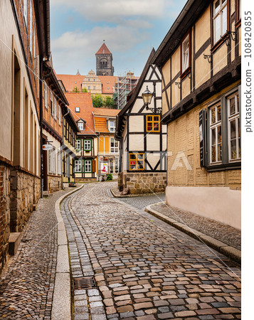 small town with old vintage small colored houses and old cobblestone pavement small town with old vintage small colored houses and old cobblestone pavement 108420855