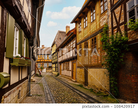 small town with old vintage small colored houses and old cobblestone pavement small town with old vintage small colored houses and old cobblestone pavement 108420917