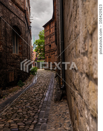 small town with old vintage small colored houses and old cobblestone pavement small town with old vintage small colored houses and old cobblestone pavement 108420923