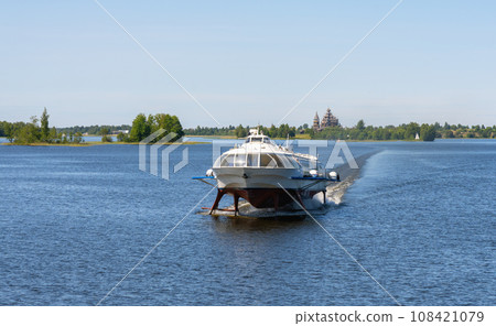 Tourist motor ship Meteor hydrofoils floating on Lake Onega against the background of the Kizhi Historical Park 108421079