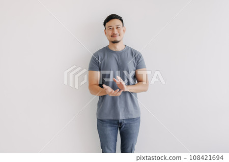 Happy man in blue t-shirt and jeans clapping hands stand isolated on white. 108421694