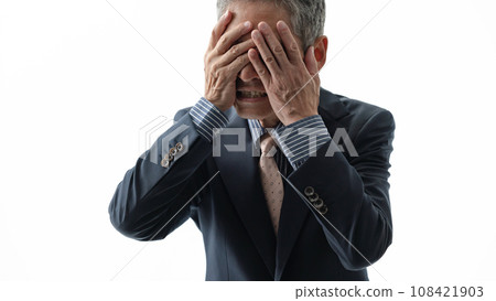 A crying man holding his face A crying man holding his face 108421903
