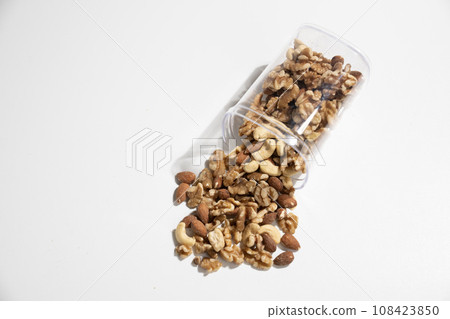 mixed nuts spilled from container mixed nuts spilled from container 108423850