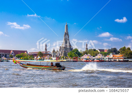 Wat Arun with the Chao Phraya River and boats in front is a popular destination for tourists around the world. Bangkok Thailand 108425037