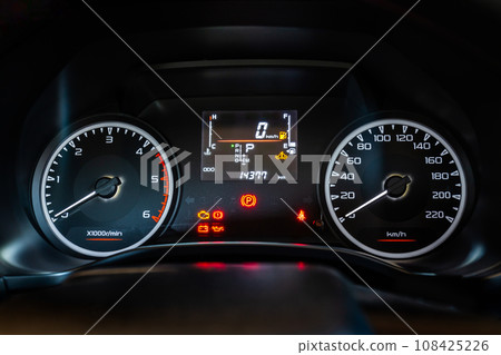 Modern car instrument dashboard panel with digital and analog screen or speedometer and symbol in night time 108425226