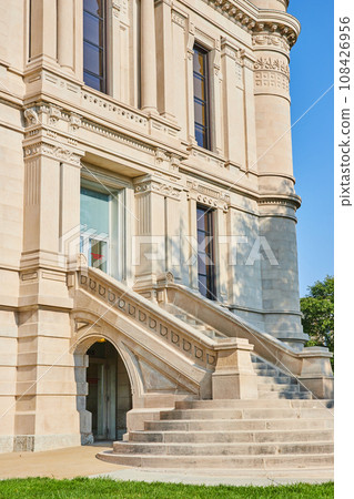 Curved steps leading up to front entrance of modern castle like building Curved steps leading up to front entrance of modern castle like building 108426956