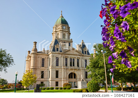 Columbia city courthouse with red and purple flowers on side of shot on sunny day 108427161