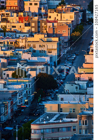 Apartments on California hillside at sunset with street cutting through neighborhoods Apartments on California hillside at sunset with street cutting through neighborhoods 108427165