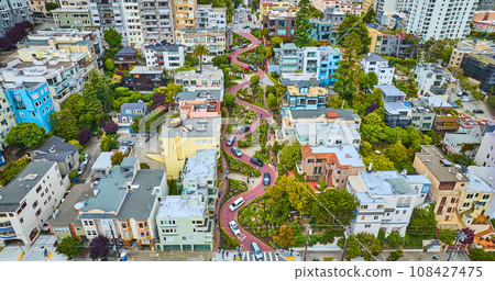 Aerial looking at Lombard Street and houses from further back with cars going down red brick road Aerial looking at Lombard Street and houses from further back with cars going down red brick road 108427475