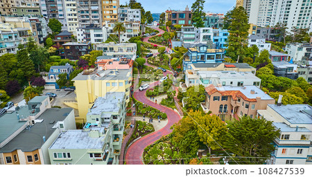 Gorgeous wider aerial of iconic Lombard Street with buildings on either side of red brick road Gorgeous wider aerial of iconic Lombard Street with buildings on either side of red brick road 108427539