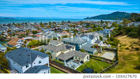 Low aerial over rich houses in Tiburon overlooking houses in Paradise Cay Yacht Harbor Low aerial over rich houses in Tiburon overlooking houses in Paradise Cay Yacht Harbor 108427670