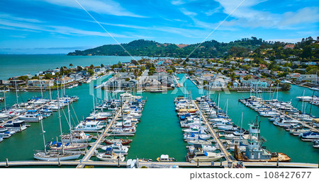 Tiburon Yacht Club boats aerial overlooking Paradise Cay Yacht Harbor with waterfront houses 108427677