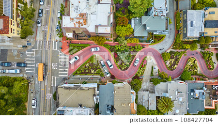 Straight down view Lombard Street top of hill with cars driving down red brick road aerial Straight down view Lombard Street top of hill with cars driving down red brick road aerial 108427704