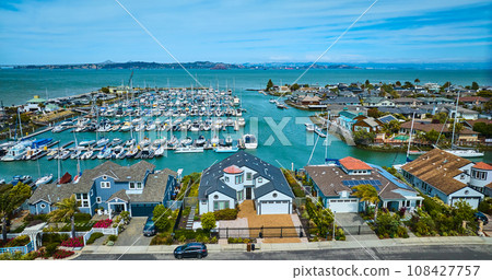 Aerial over street with rich houses overlooking Paradise Cay Yacht Harbor with boats Aerial over street with rich houses overlooking Paradise Cay Yacht Harbor with boats 108427757