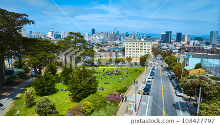 Aerial Alamo Square lawn with people looking at The Painted Ladies and city skyline Aerial Alamo Square lawn with people looking at The Painted Ladies and city skyline 108427797