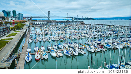 Aerial South Beach Harbor and Pier 40 with Oakland Bay Bridge on skyline 108428186
