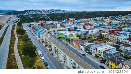 Long road beside two colorful cities with murphy windmill between them aerial Long road beside two colorful cities with murphy windmill between them aerial 108428304