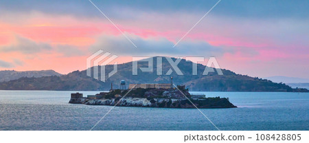 Alcatraz Island panorama with gorgeous pink and yellow sunset over blue San Francisco Bay Alcatraz Island panorama with gorgeous pink and yellow sunset over blue San Francisco Bay 108428805