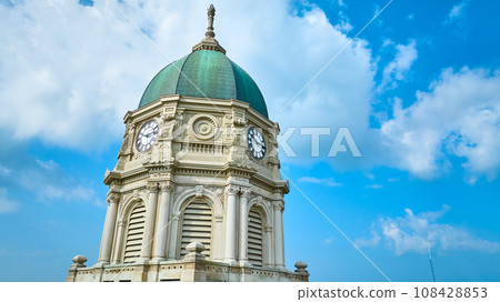 Aerial upward view of Columbia City courthouse clock tower with dome and blue sky with clouds 108428853