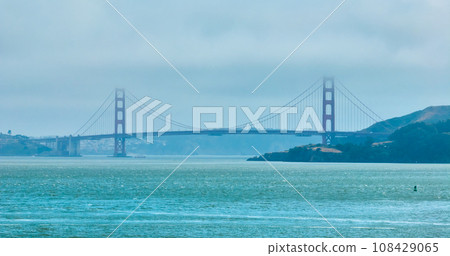 Golden Gate Bridge covered in hazy fog aerial of full bridge side view 108429065