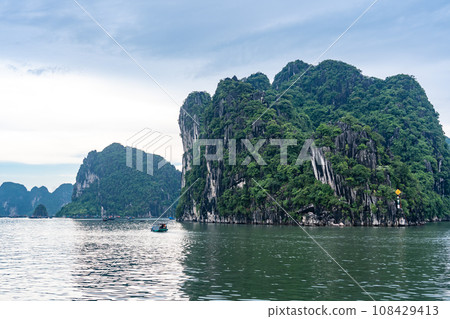 Strangely shaped rocks and fishing boats in Ha Long Bay, Vietnam Strangely shaped rocks and fishing boats in Ha Long Bay, Vietnam 108429413